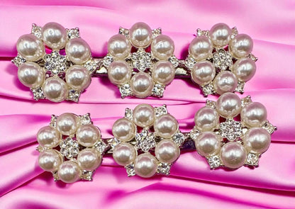 Pearl and crystal hair clips on a pink satin background