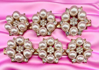 Pearl and crystal hair clips on a pink satin background