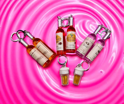 Set of bottle-shaped  earrings on a pink swirling background