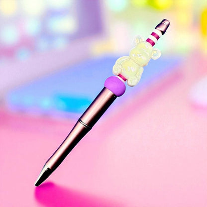 Colorful pen with a decorative top on a pastel background