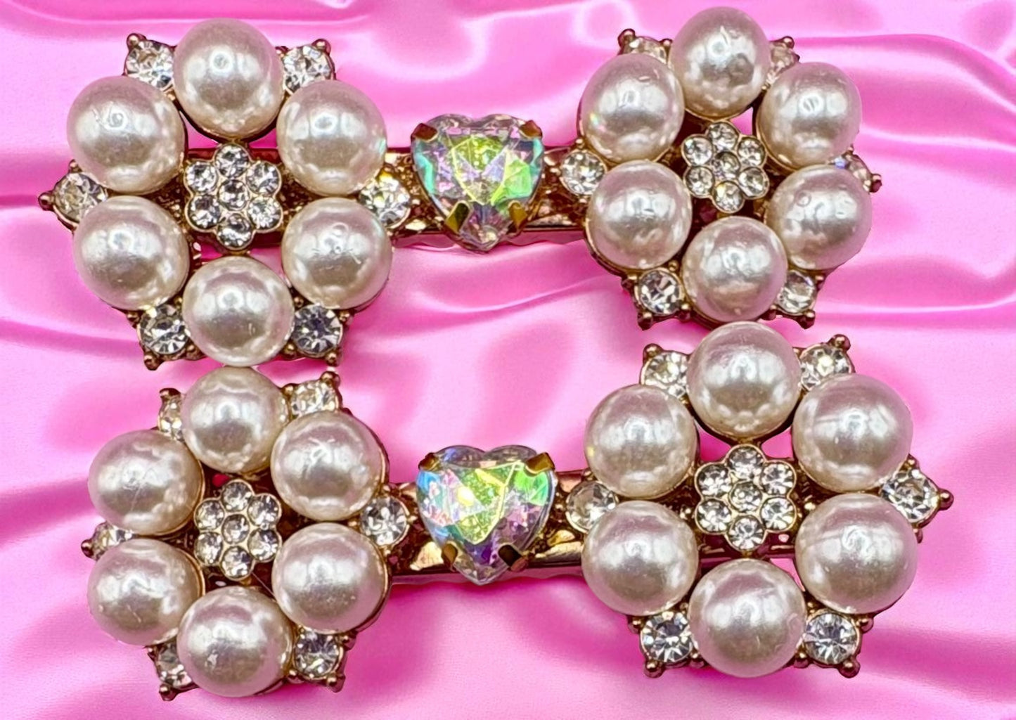 Pearl and gemstone decorative hair clips  on a pink satin background