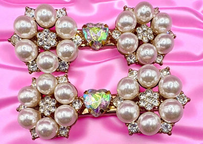 Pearl and gemstone decorative hair clips  on a pink satin background
