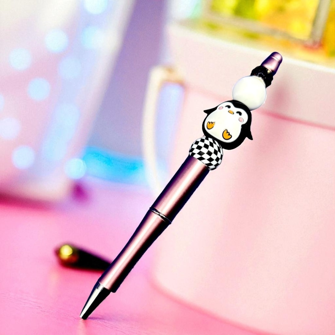 Pen with a penguin-shaped cap on a colorful background