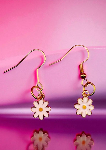 Flower-shaped earrings on a pink background