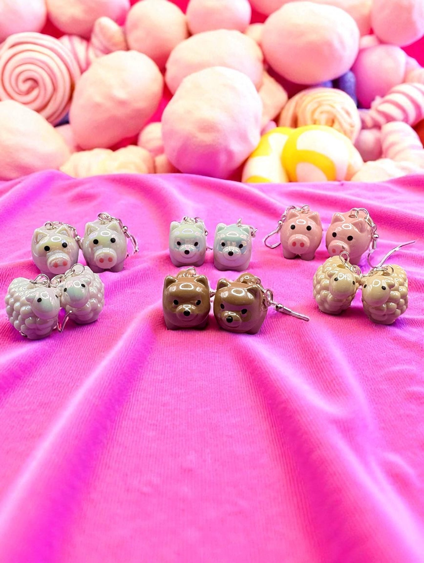 Small animal figurines on a pink surface with a colorful background
