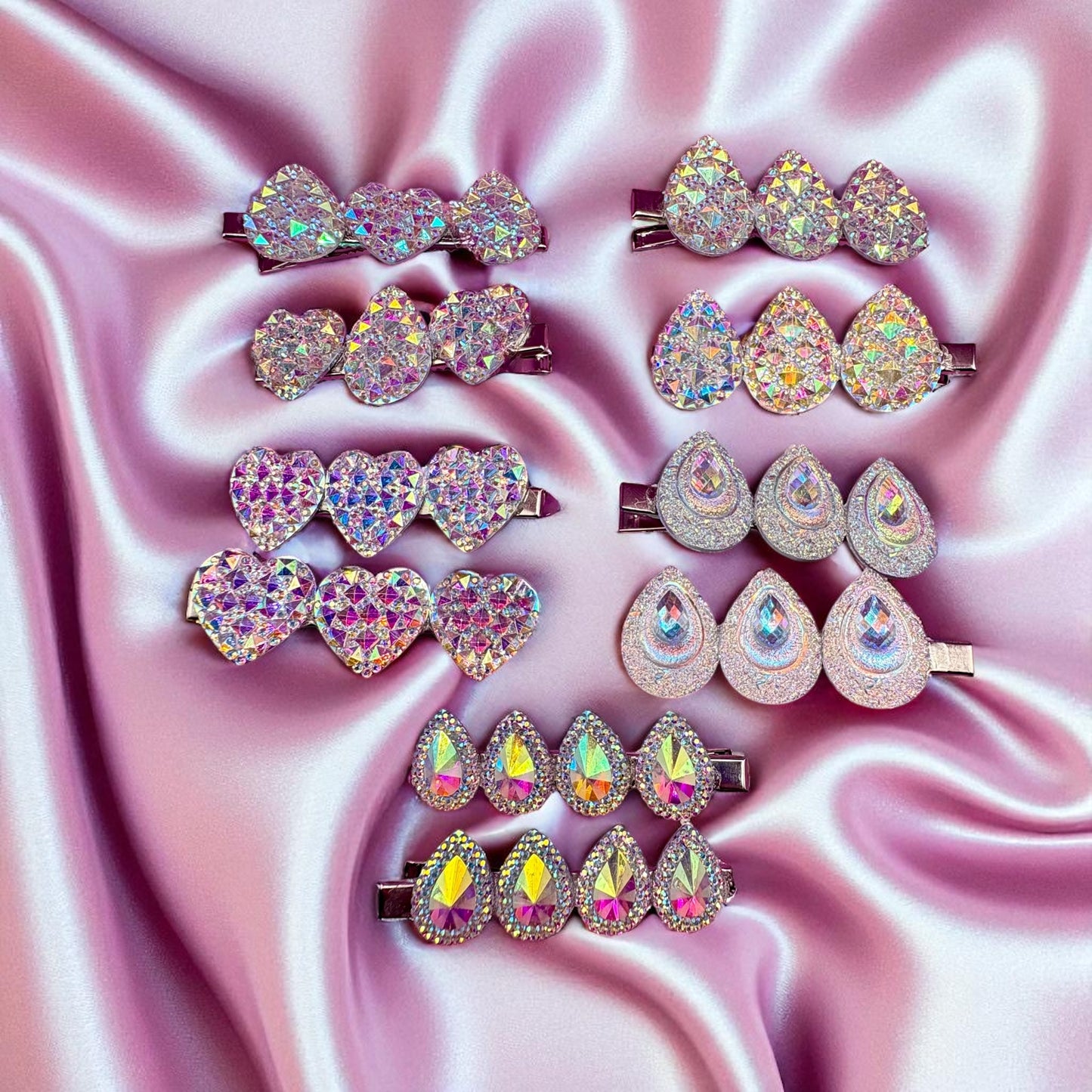 Set of sparkling hair clips on a pink satin background