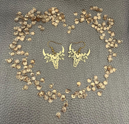 Stylish gold dangly earrings featuring a unique bull design, perfect for animal lovers and adding a bold statement to any outfit