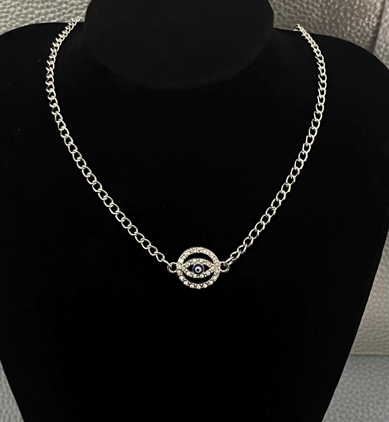 Circular diamanté evil eye centred necklace- colour silver