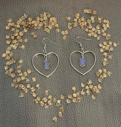 Stylish silver heart hoop dangly earrings, featuring a trendy design perfect for adding a romantic touch to any outfit.