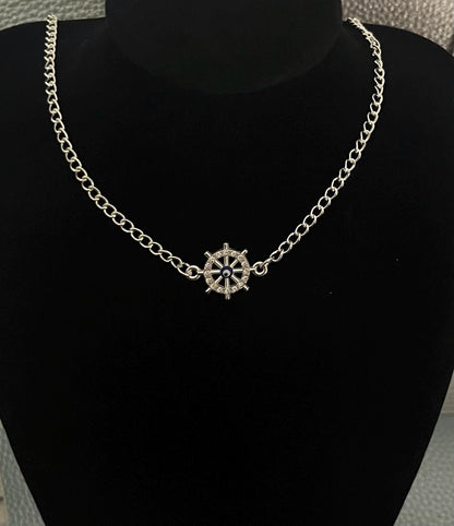 Ship Wheel Evil Eye Necklace showcasing a nautical helm design embellished with an evil eye symbol, crafted for style and protection, ideal for ocean lovers and as a meaningful gift.
