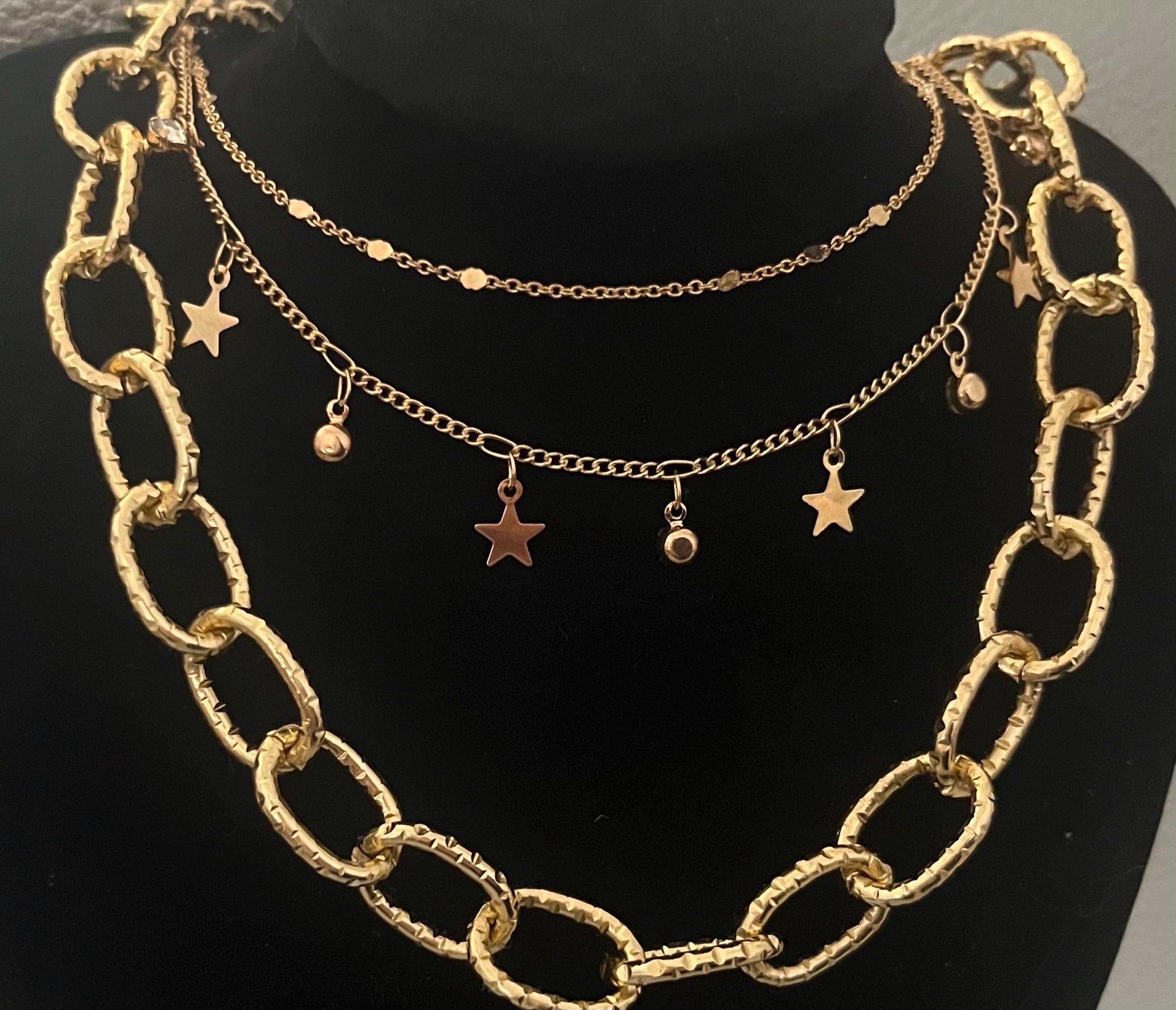 Elegant gold necklace set featuring three versatile necklaces, perfect for layering and enhancing any outfit with a touch of sophistication and style.
