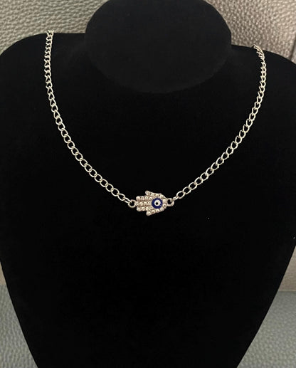 Evil Eye hand necklace adorned with sparkling diamantes, offering protection and style, perfect for layering or as a statement piece.