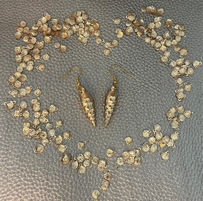 Elegant gold sea shell horn earrings, featuring a unique coastal-inspired design that adds a touch of beachy charm and sophistication to any outfit.