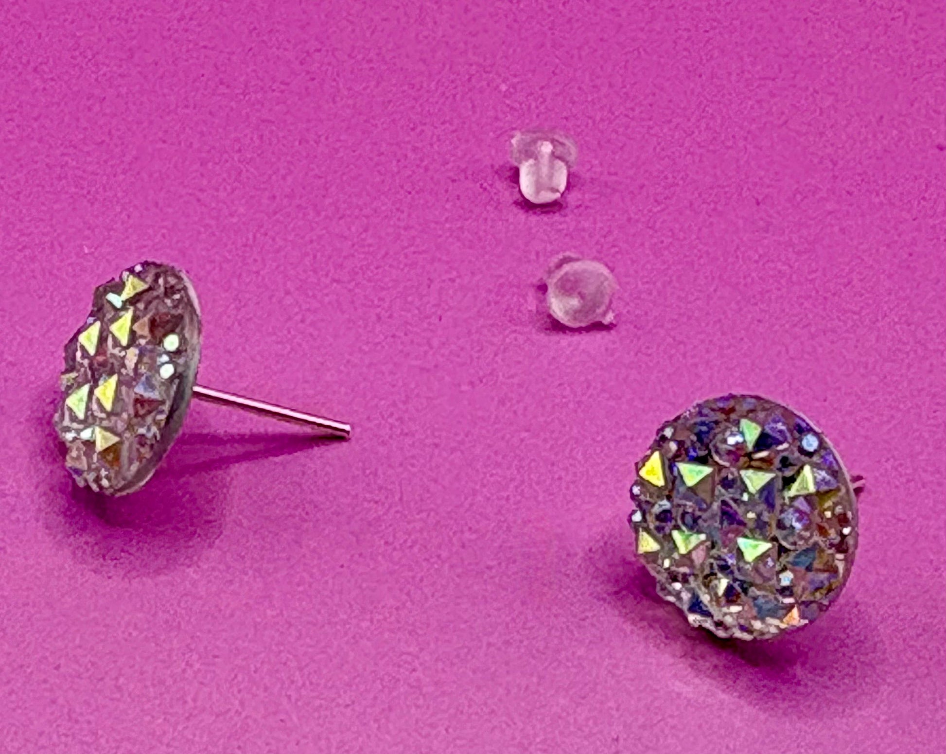 Dazzling silver stud earrings with sparkling gemstones, perfect for adding a touch of elegance and shine to any outfit for both casual and formal occasions.