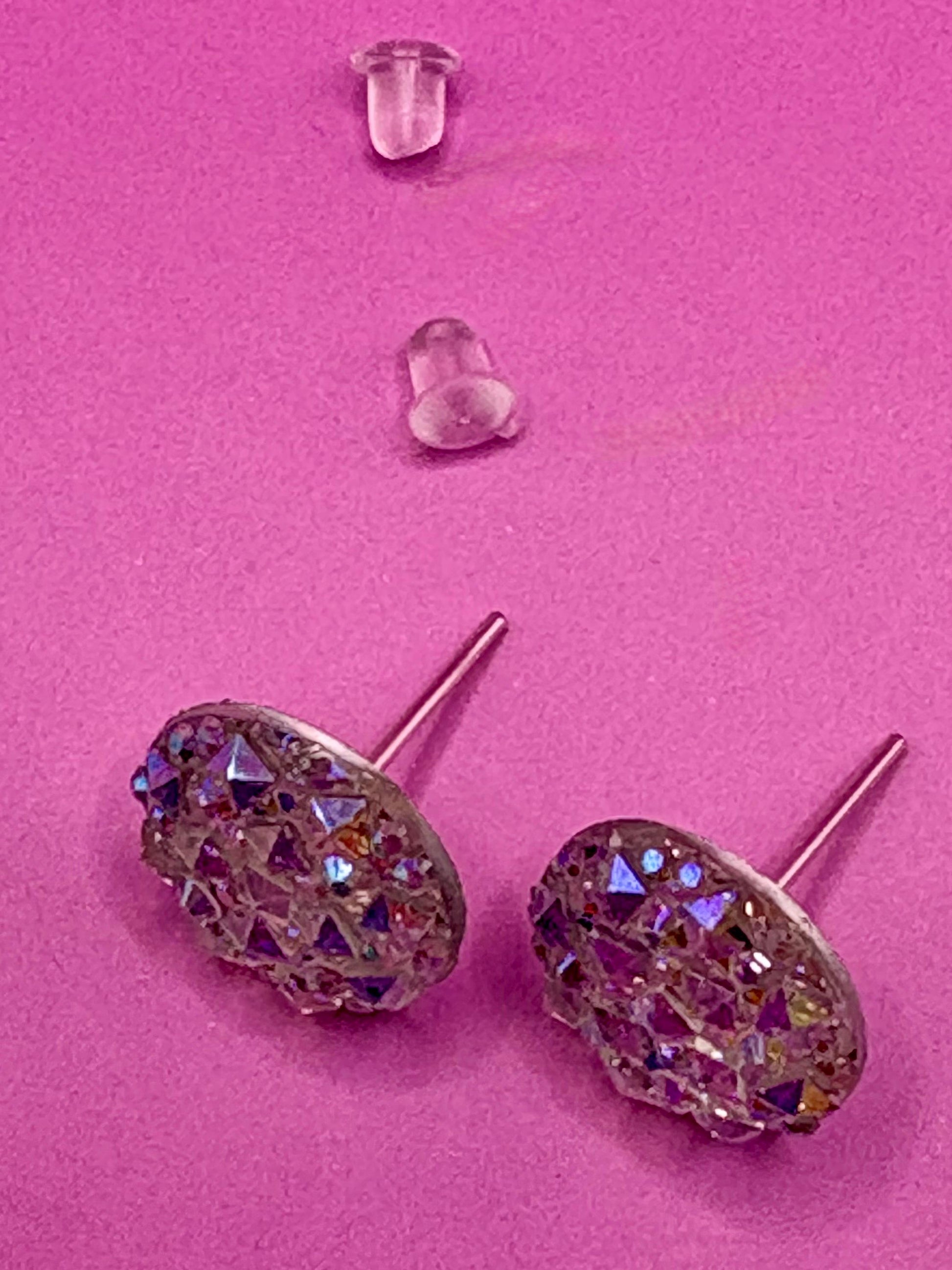 Dazzling silver stud earrings with sparkling gemstones, perfect for adding a touch of elegance and shine to any outfit for both casual and formal occasions.