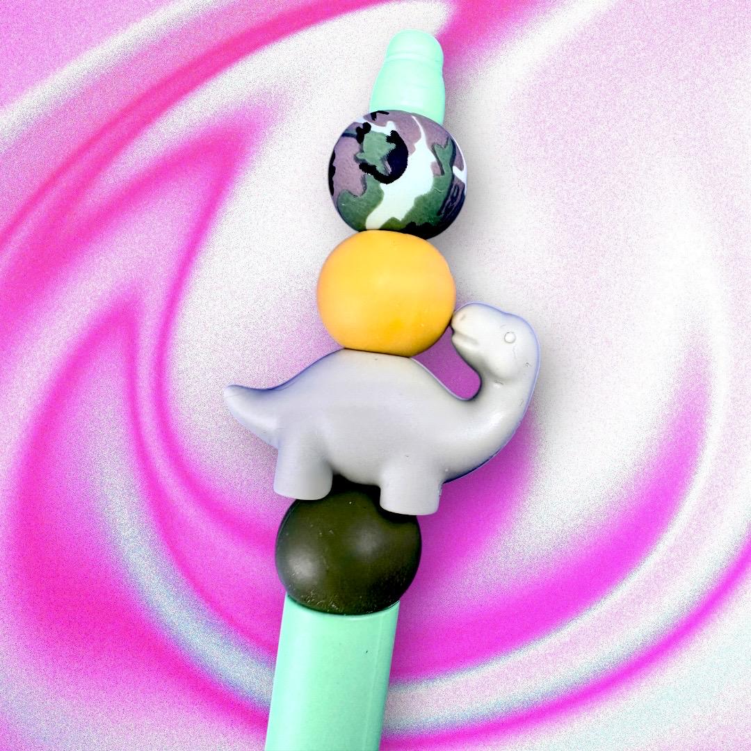 Elevate your writing experience with our delightful Dinosaur-Themed Black Ballpoint Pens! Each pen features a whimsical design, complete with colorful beads including camouflage and adorable pink or grey dinosaur toppers, making them the perfect addition to your stationery collection or a standout gift for anyone who loves fun and functionality.
