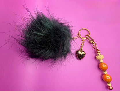 bag charm keychain orange beads gold leopard print heart pendant and black fluffy ball