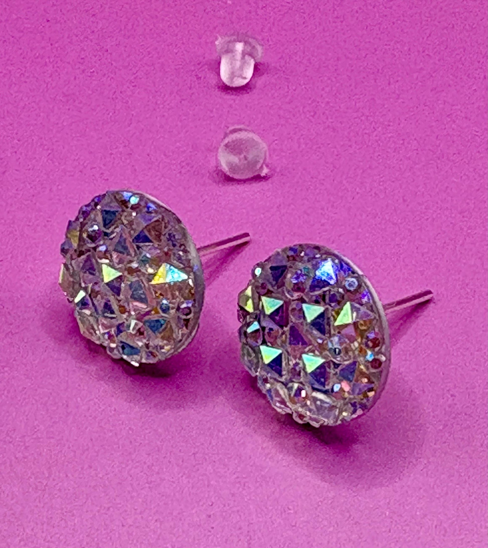 Dazzling silver stud earrings with sparkling gemstones, perfect for adding a touch of elegance and shine to any outfit for both casual and formal occasions.