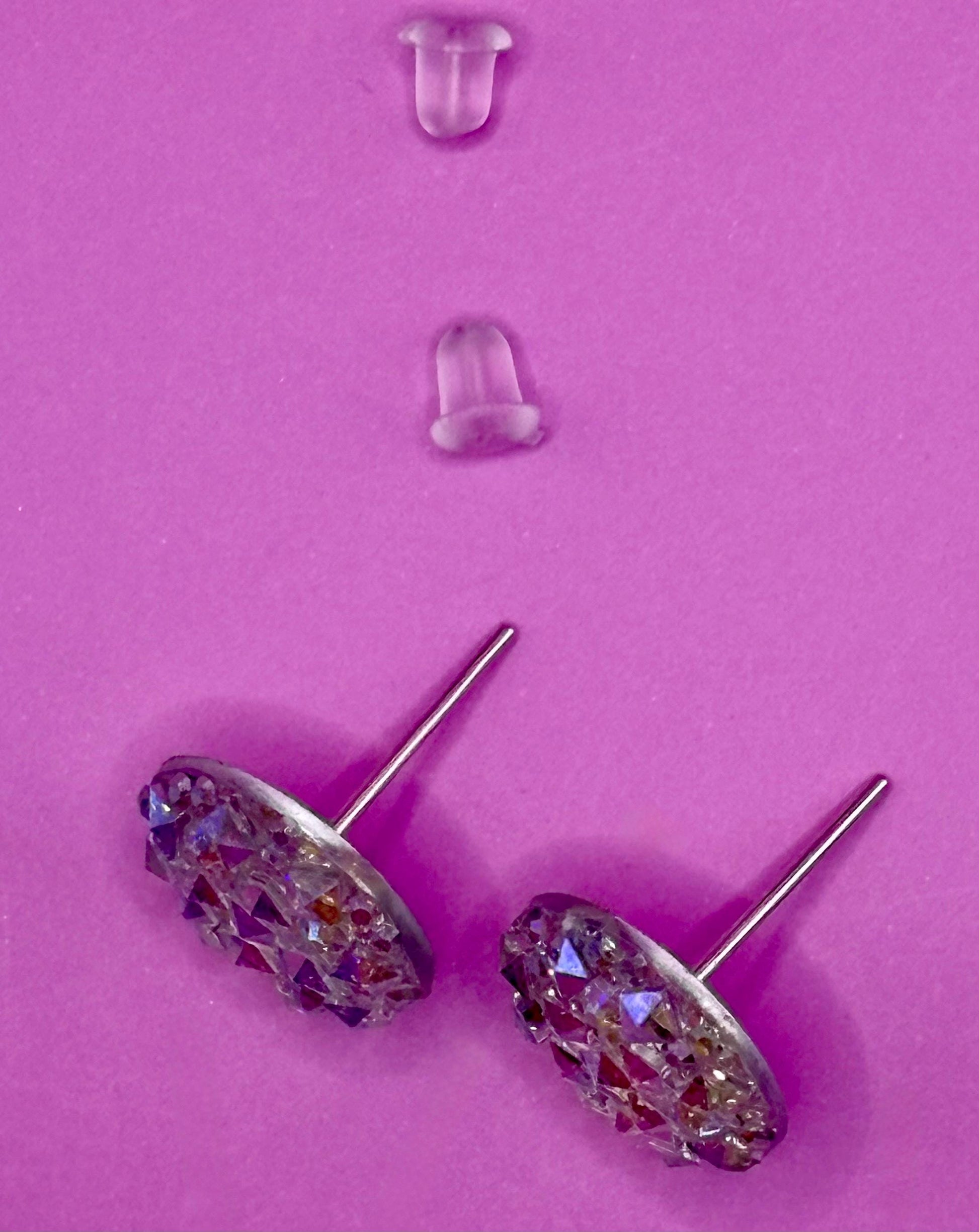 Dazzling silver stud earrings with sparkling gemstones, perfect for adding a touch of elegance and shine to any outfit for both casual and formal occasions.