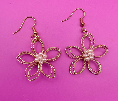 Gold look flower pearly centre dangly earrings