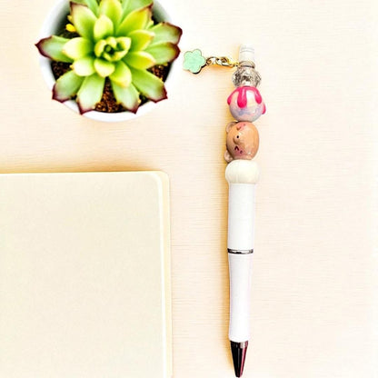 Handcrafted black ballpoint pens with adorable gummy bear and teddy bear charms.
