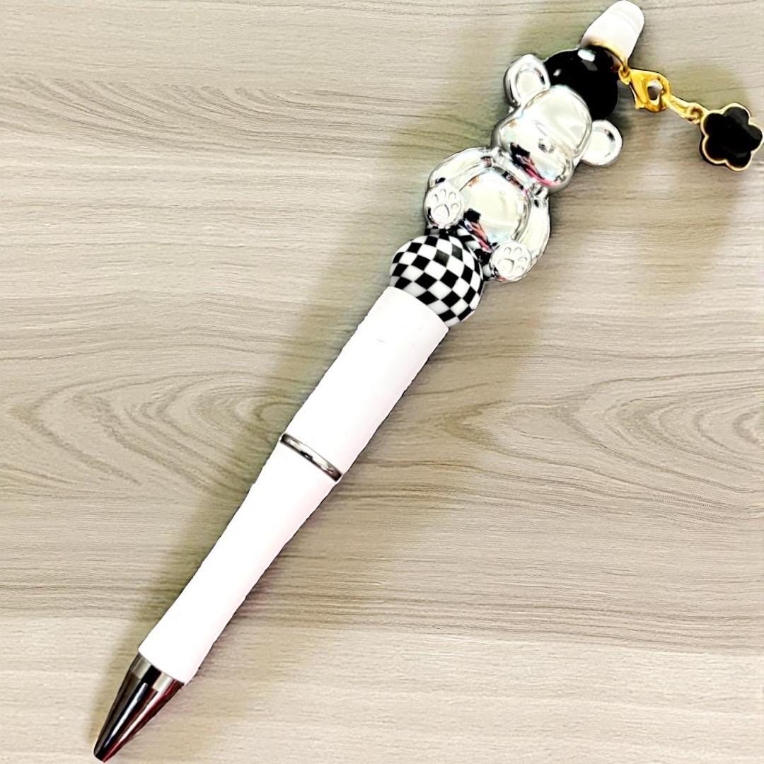Handcrafted black ballpoint pens with adorable gummy bear and teddy bear charms.