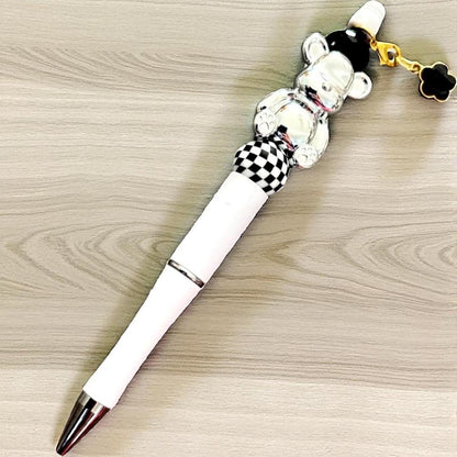 Handcrafted black ballpoint pens with adorable gummy bear and teddy bear charms.