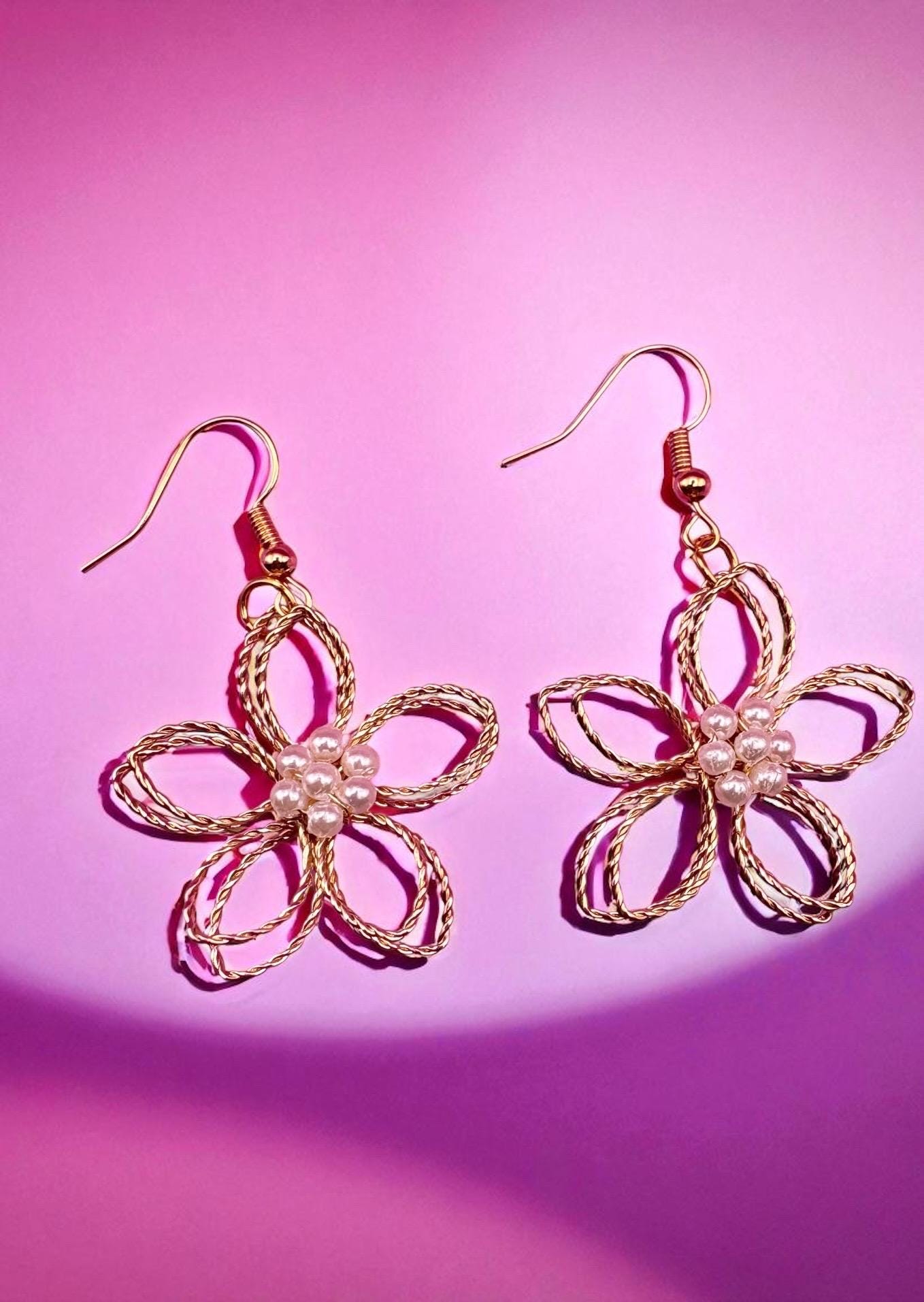 Gold look flower pearly centre dangly earrings