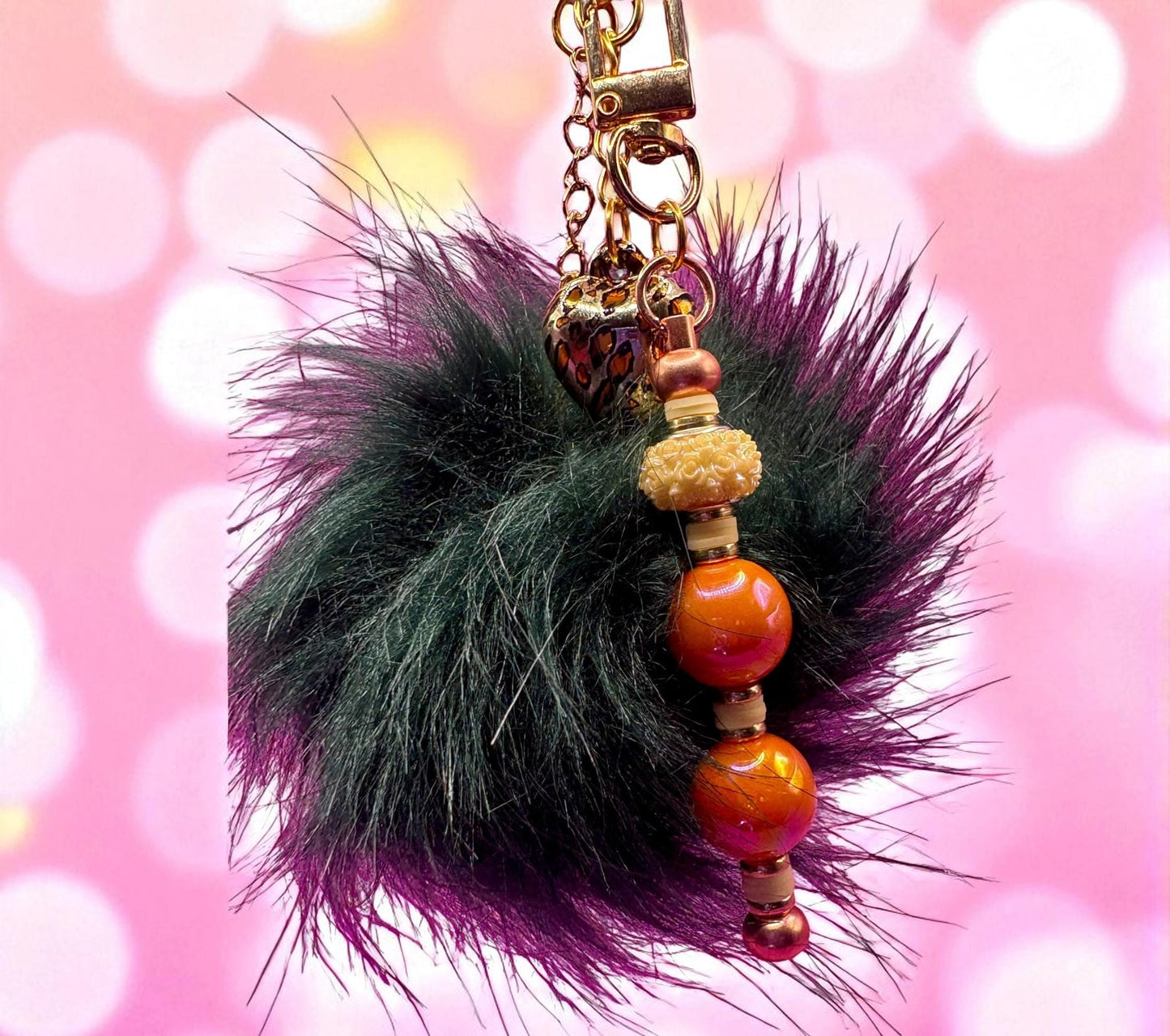 bag charm keychain orange beads gold leopard print heart pendant and black fluffy ball