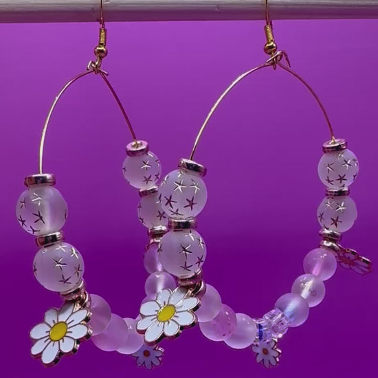Stylish handmade beaded hoop earrings in a daisy gold design, featuring vibrant colors and floral accents, perfect for adding a touch of elegance to any outfit and ideal for spring and summer fashion.