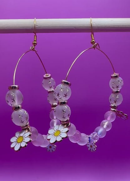 Stylish handmade beaded hoop earrings in a daisy gold design, featuring vibrant colors and floral accents, perfect for adding a touch of elegance to any outfit and ideal for spring and summer fashion.