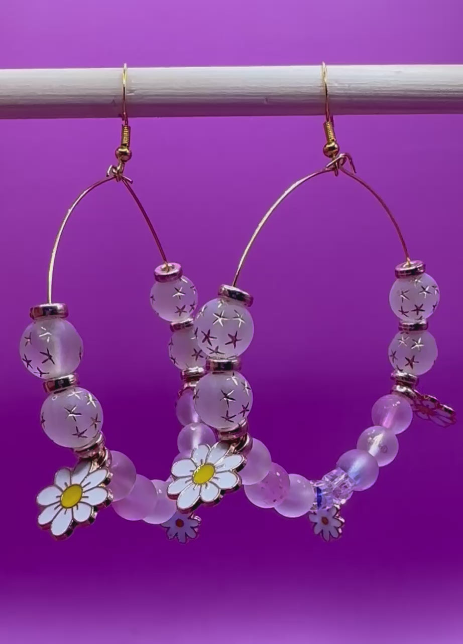 Stylish handmade beaded hoop earrings in a daisy gold design, featuring vibrant colors and floral accents, perfect for adding a touch of elegance to any outfit and ideal for spring and summer fashion.