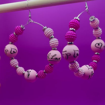 Charming handmade beaded hoop earrings featuring the phrase 'I Love You' in a unique design, perfect for expressing love and adding a personal touch to any outfit, ideal for gifts and special occasions.
