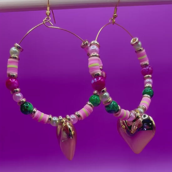Handmade beaded hoop earrings in pink and green, showcasing vibrant colors and intricate craftsmanship, perfect for adding a playful touch to any outfit and ideal for casual or festive occasions.