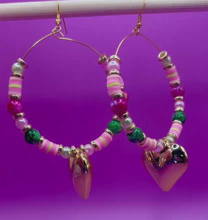 Handmade beaded hoop earrings in pink and green, showcasing vibrant colors and intricate craftsmanship, perfect for adding a playful touch to any outfit and ideal for casual or festive occasions.